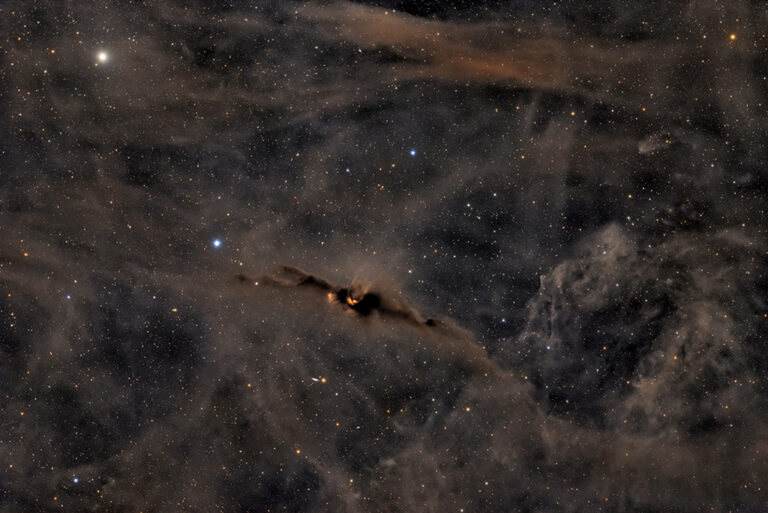 The Red Glow of the Cosmic Bat Nebula