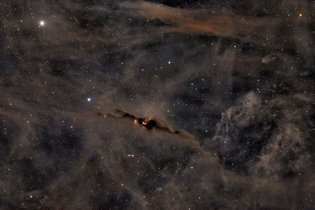 The Red Glow of the Cosmic Bat Nebula